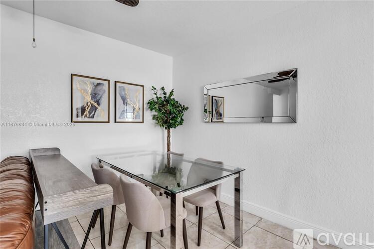 A modern dining room with a glass table and chairs.