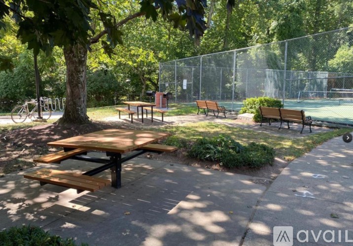 A park with a picnic table and benches.