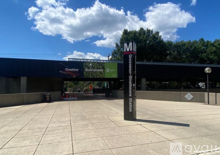 A sign for a creative environment is displayed in front of a building.
