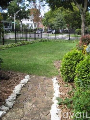 A garden pathway with white stones on the sides.
