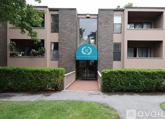 The image shows a building entrance with a blue sign above it.