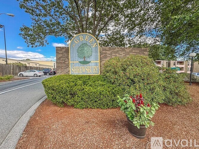 A sign for Shrewsbury is in front of a building.