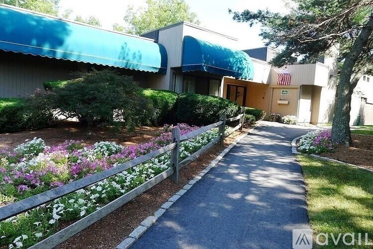 A building with a blue awning and a flag on it.