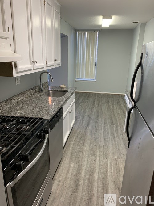 A kitchen with a granite countertop and stainless steel appliances.