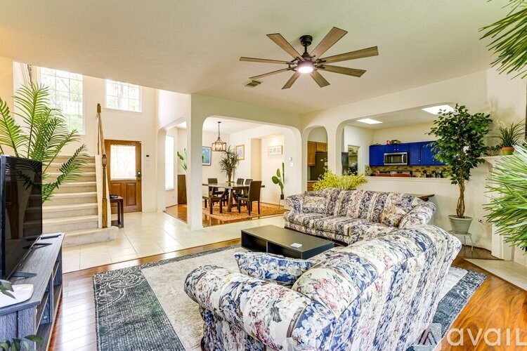 A living room with a couch and a television.