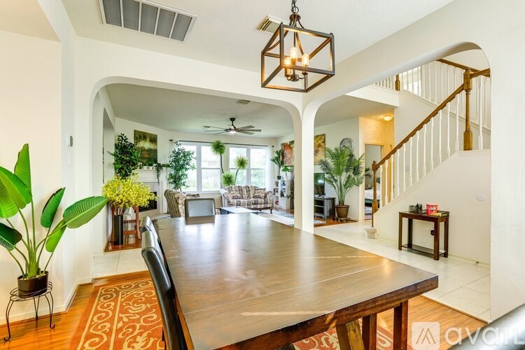 A dining room with a wooden table and chairs.
