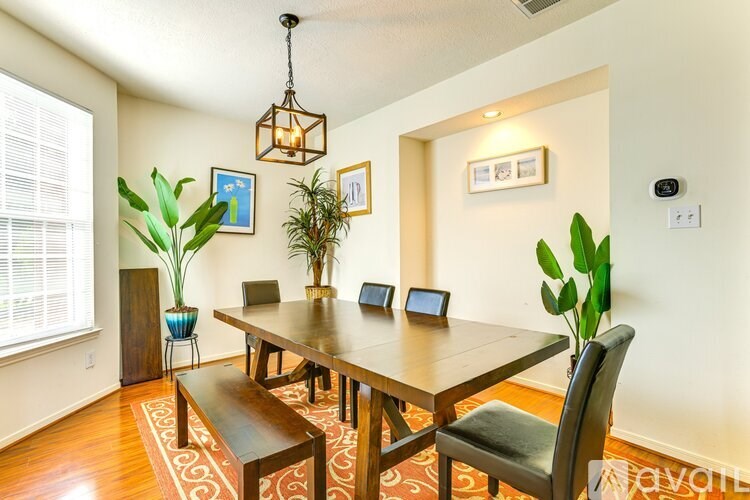A dining room with a wooden table and chairs.