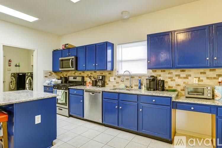 A kitchen with blue cabinets and appliances.