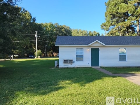 A white house with a green door and a small porch.