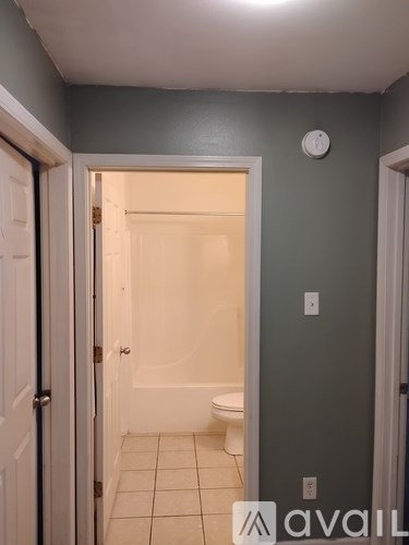 A bathroom with a toilet and a door.