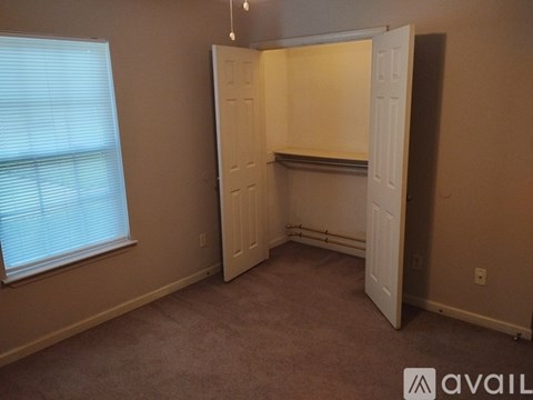A room with a carpeted floor and a white door.