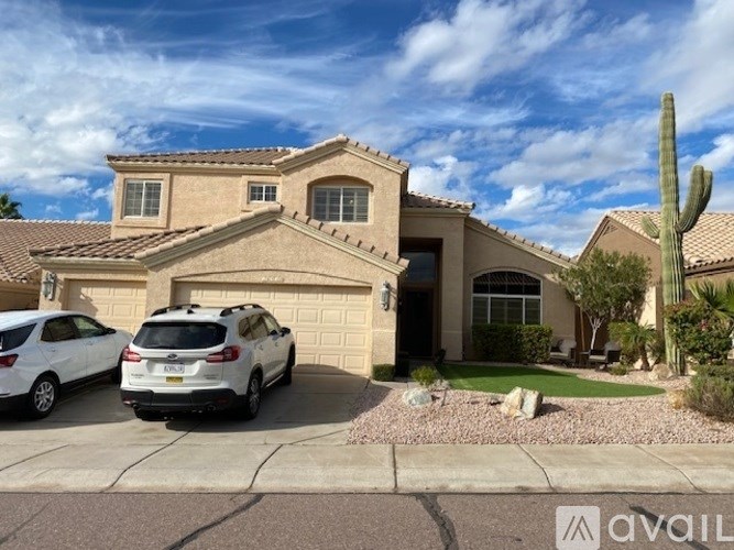 A house with a cactus in front of it.