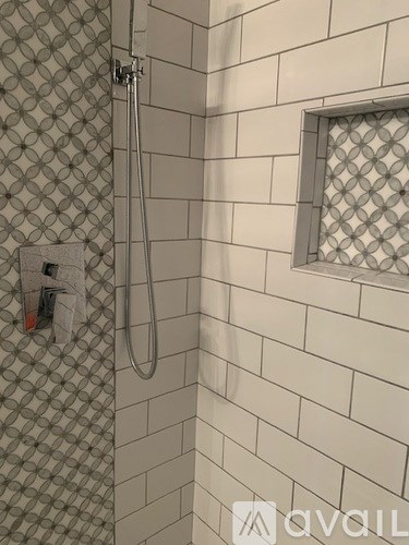 A shower area with a glass block window.