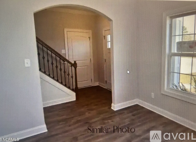 A room with a staircase and a window.