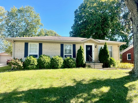 A house with a blue front door and a red garage door.