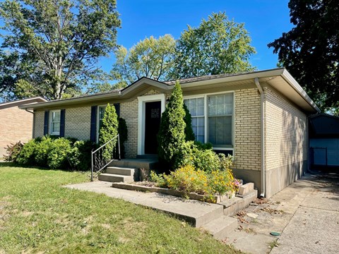 A house with a front yard and a driveway.