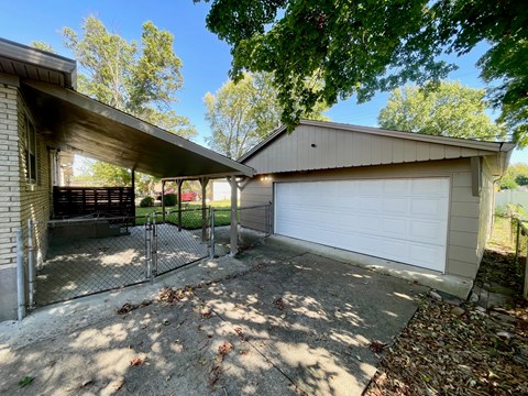 A detached house with a garage and a covered patio.