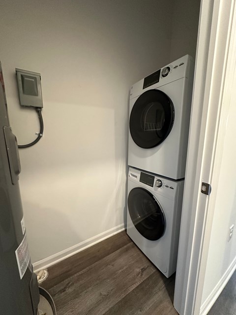 A washing machine is placed next to a dryer in a small room.
