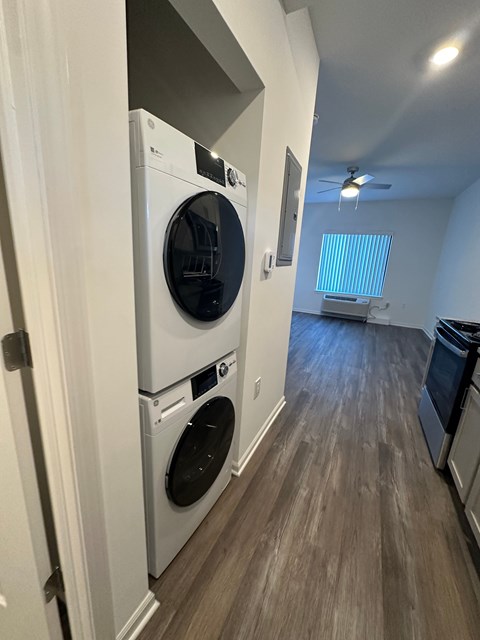 A laundry room with a washer and dryer stacked on top of each other.