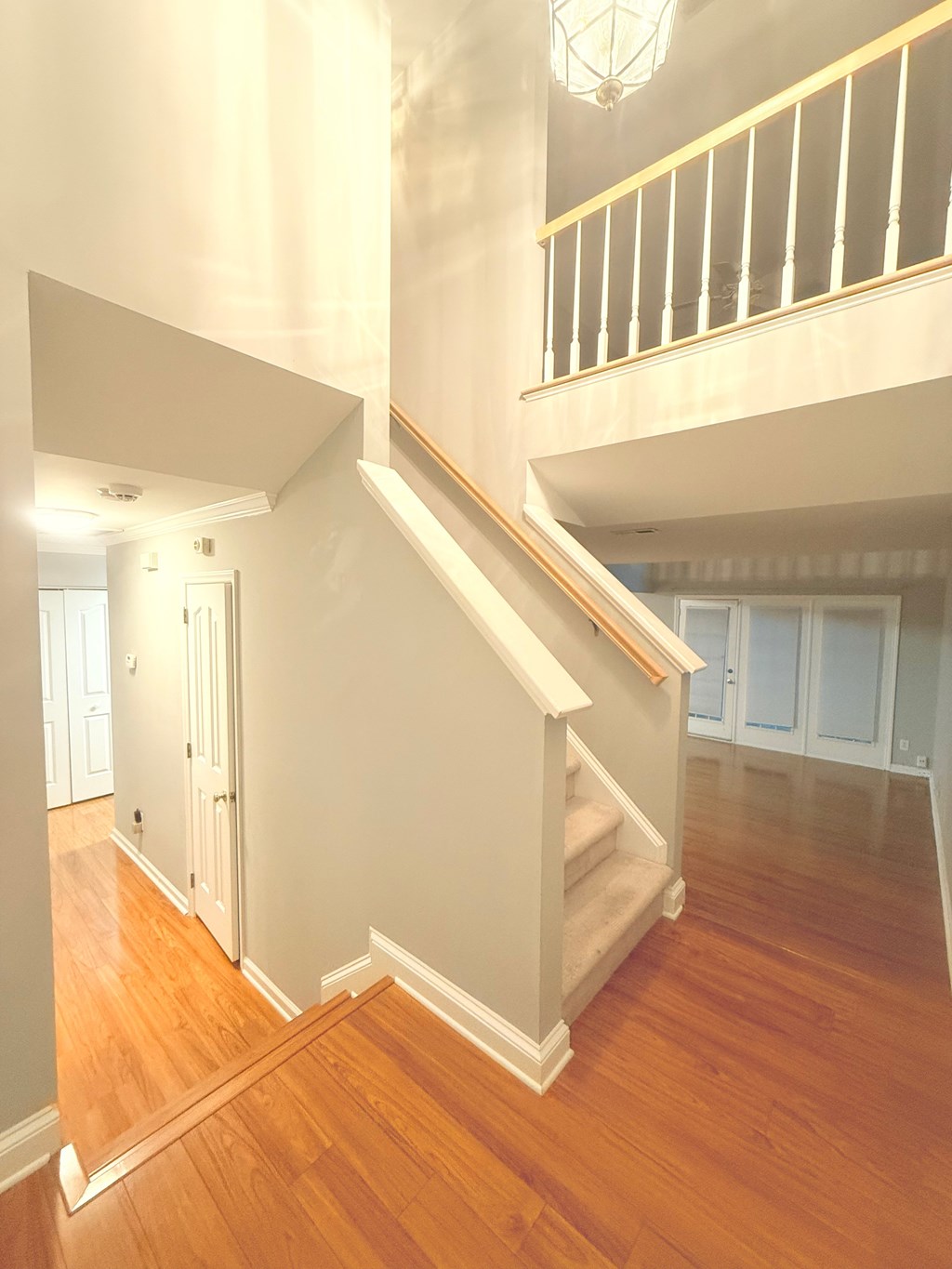 A staircase with a white railing and wooden steps.