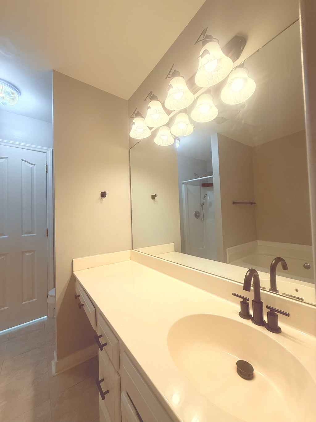 A bathroom with a sink and mirror.