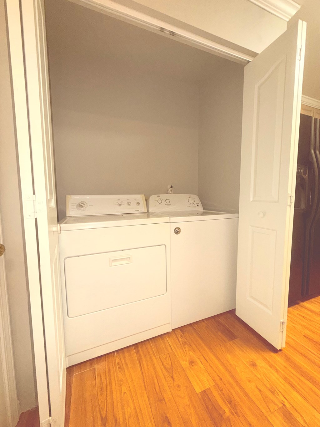 A white built in washer and dryer in a small room.