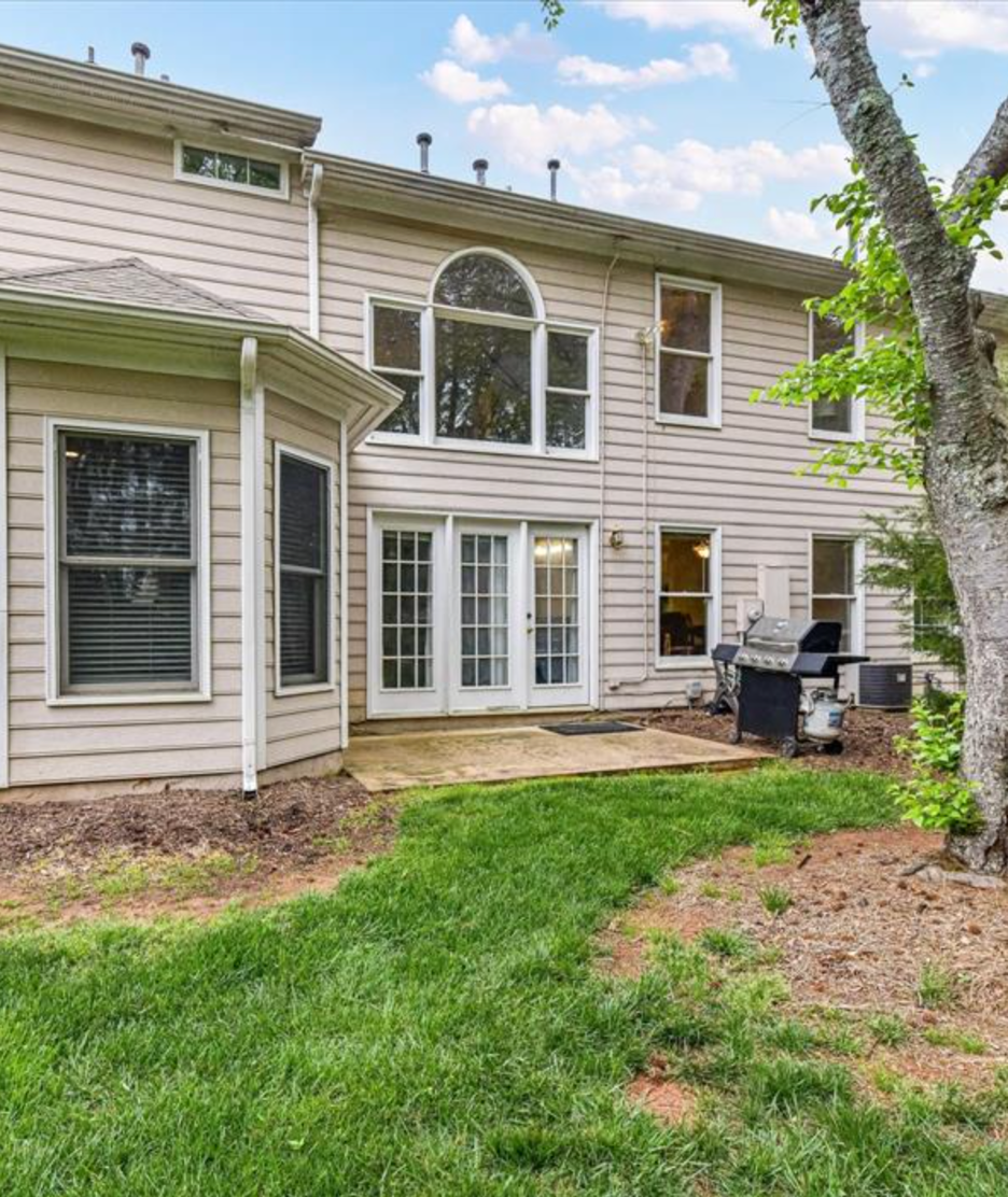 A house with a tree in front of it.