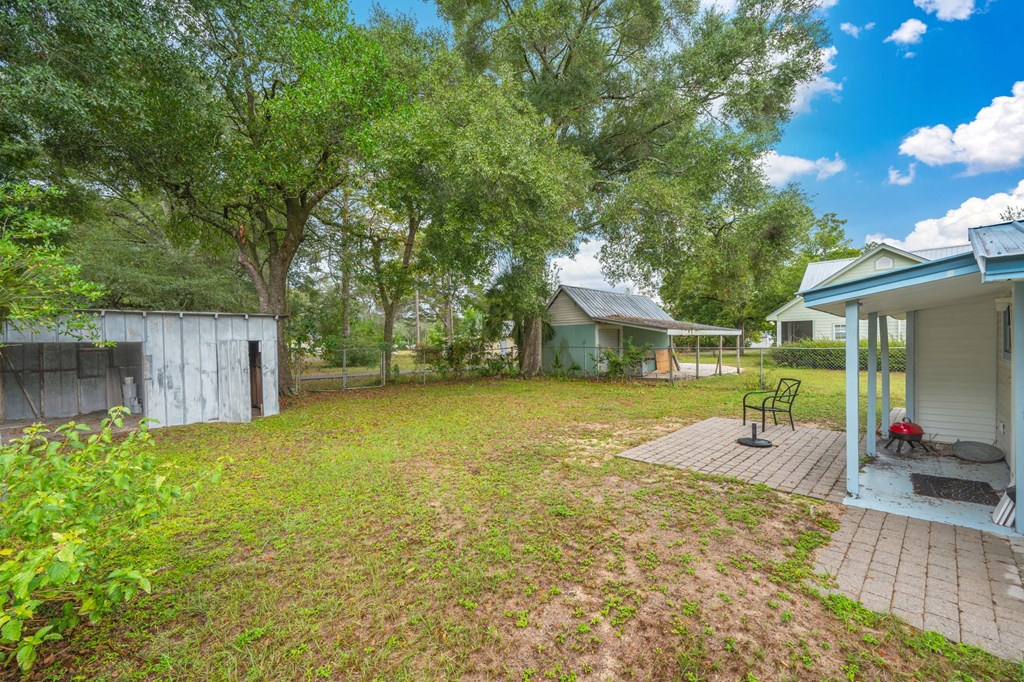 A backyard with a wooden deck and a shed.