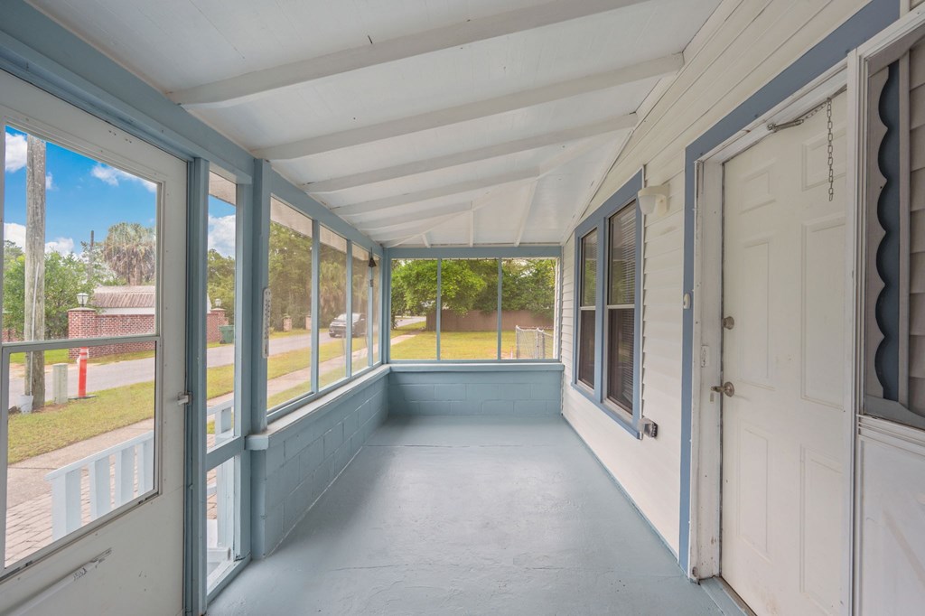 A sunny day at the beach with a blue sky and white clouds.