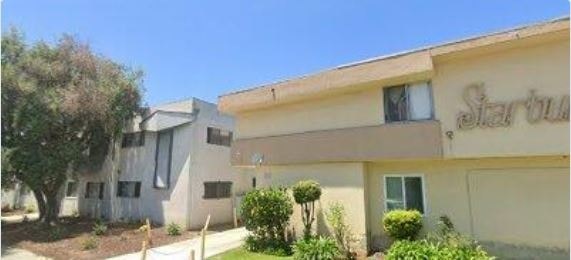 A building with the word "Starbucks" on the top of it.