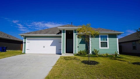 A house with a blue garage door and a white wall.