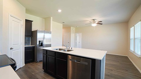 A kitchen with dark wood cabinets and stainless steel appliances.
