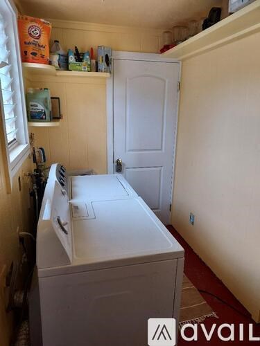 A small laundry room with a washer and dryer.