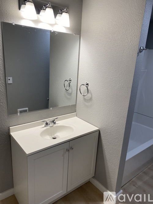 A bathroom with a sink and mirror.