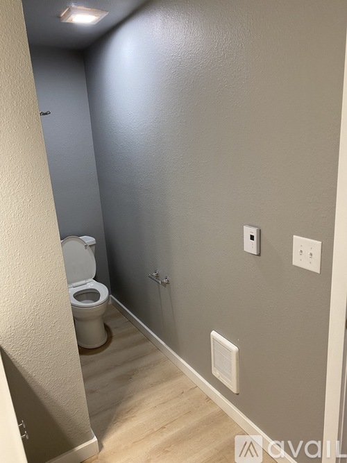 A bathroom with a toilet and a shower stall.
