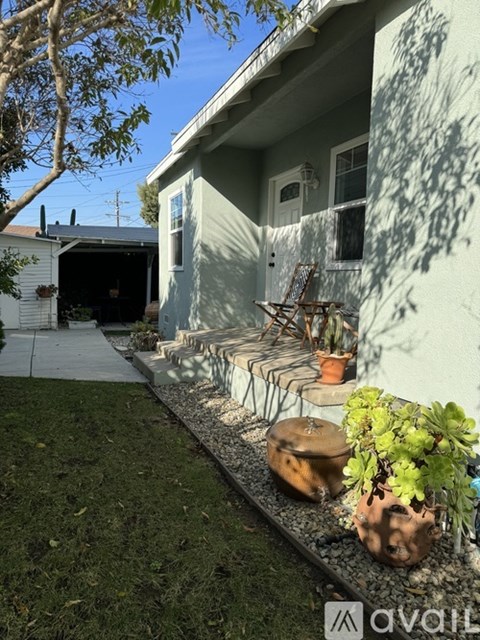 A house with a green wall and a white door.