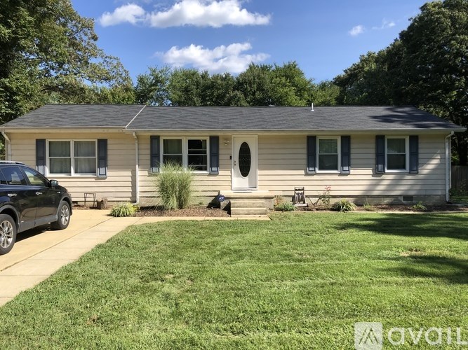 A house with a car parked in front of it.