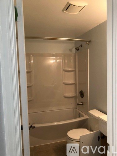 A bathroom with a toilet, tub, and sink.