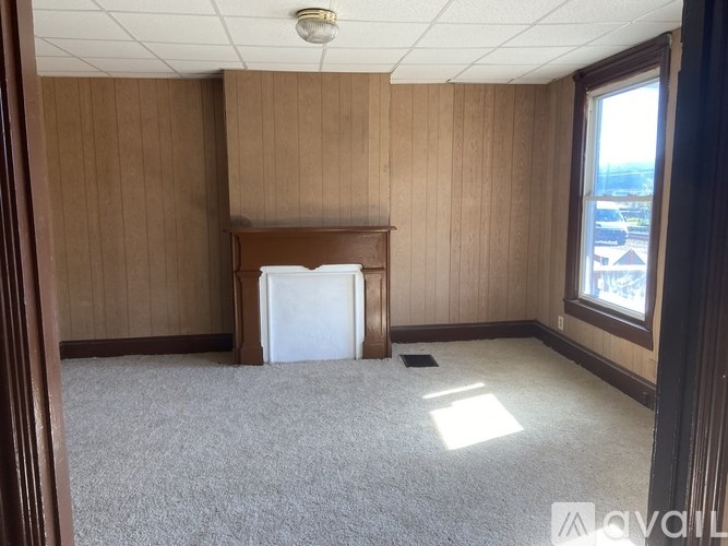 A room with wooden paneling and a carpeted floor.