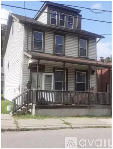 A two-story house with a porch and a balcony.