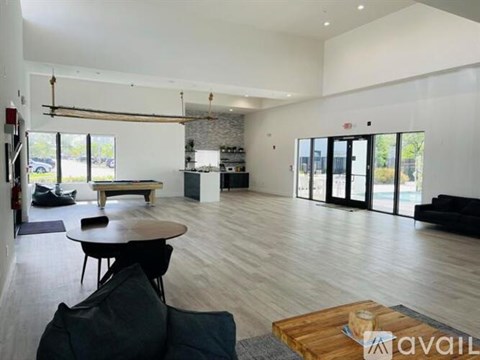A spacious living room with a dining table and chairs.