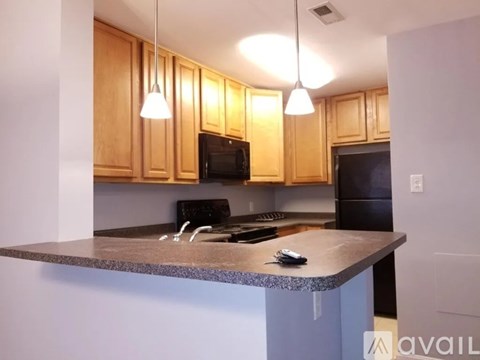 A kitchen with wooden cabinets and a granite countertop.