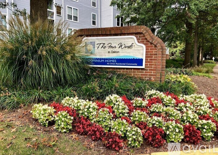 A brick sign that says 7th Floor West in front of a building.