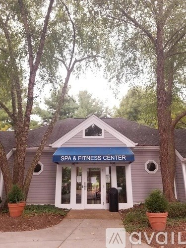 A Spa and Fitness Center is surrounded by trees.