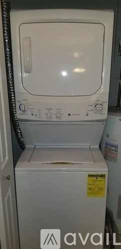 A white dishwasher with a sticker on the door.