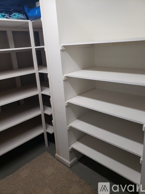 A white shelving unit with multiple shelves is shown.