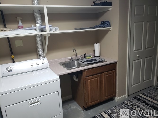 A small laundry room with a washer and dryer.