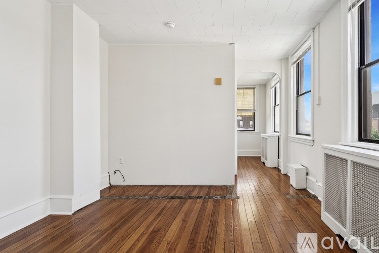 A room with wooden floors and white walls.