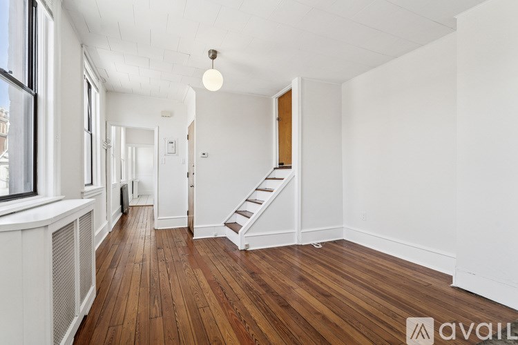 A room with wooden floors and white walls.