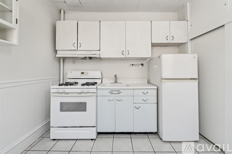 A white kitchen with a stove, oven, dishwasher, and refrigerator.